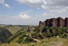 una fortezza in pietra su delle colline verdi