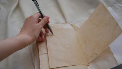 una mano che scrive su un foglio, la mano è chiaramente la sinistra che indica utilizzatore mancino