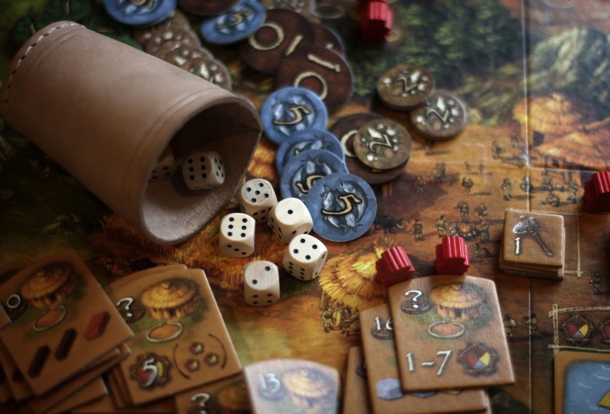 un tabellone, dei dadi da gioco e pedine per dei board games da tavolo