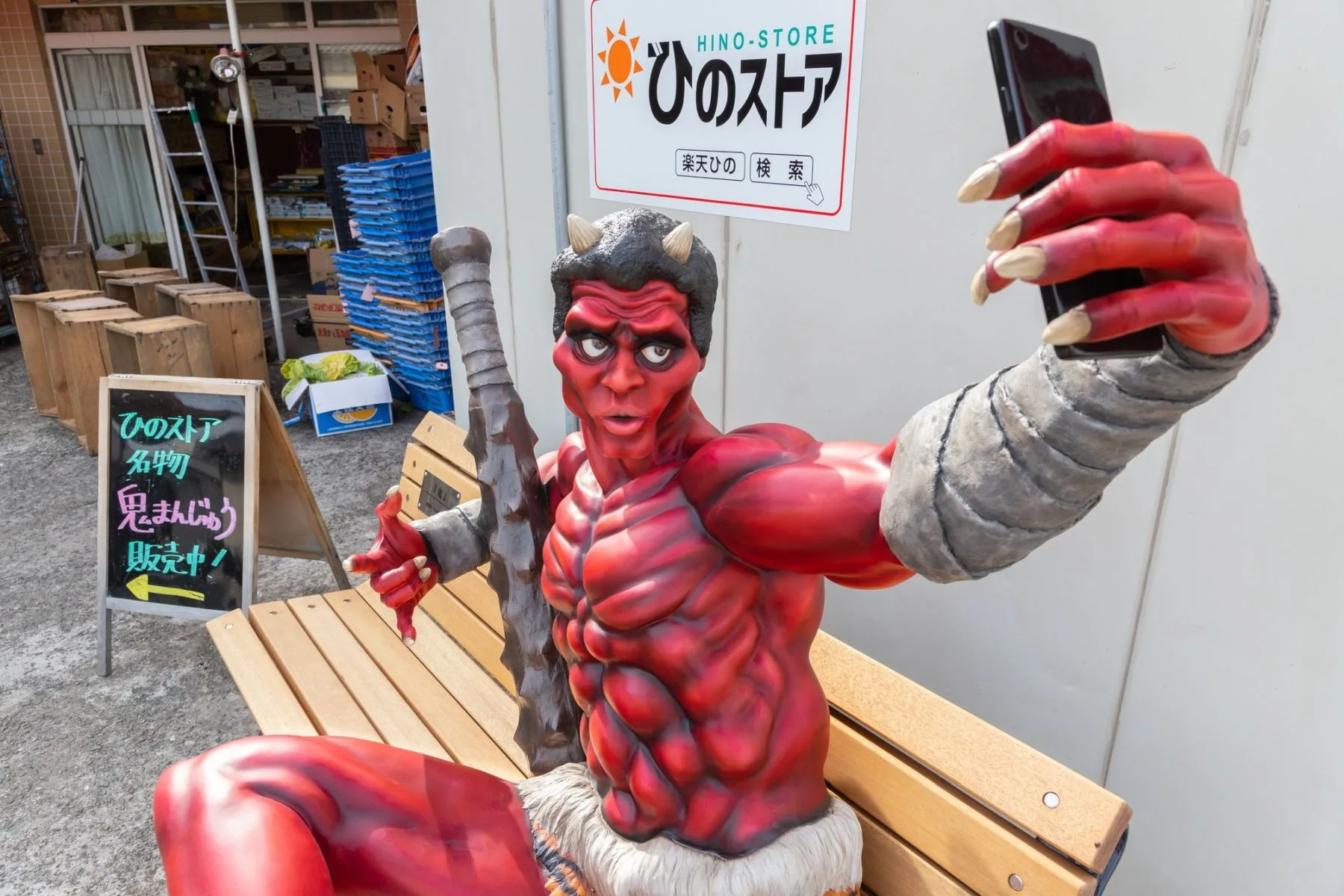 la statua di uno yokai rosso su una pankina di fukusaki, città giapponese